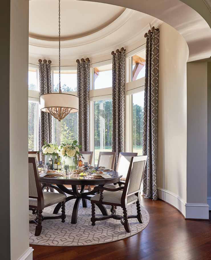 Above: Soaring fifteen-foot windows and a tray ceiling create drama while dining.