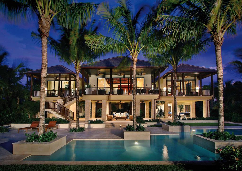 Exterior touches such as coquina shell stone walkways and planters, unique water features and integrated outdoor lighting create a residence that is as magical after sunset as it is welcoming during