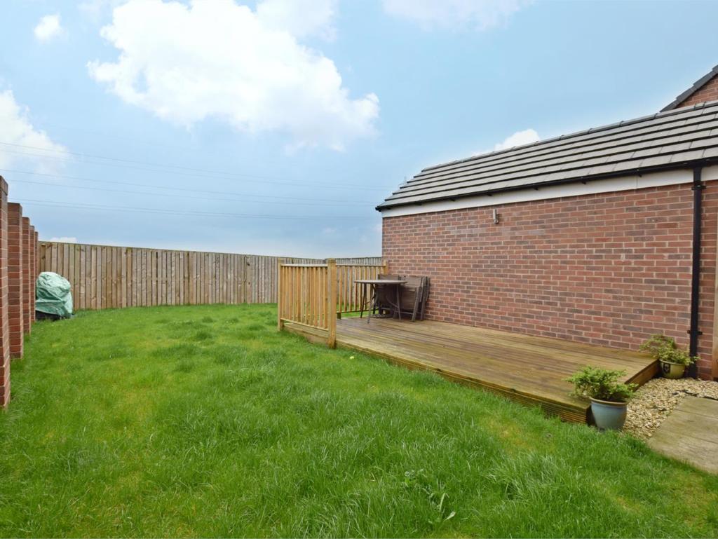 OUTSIDE The property enjoys a generous plot with spacious garden fully enclosed with perimeter fencing and walling predominantly lawned but there is also a raised decked area providing seating space