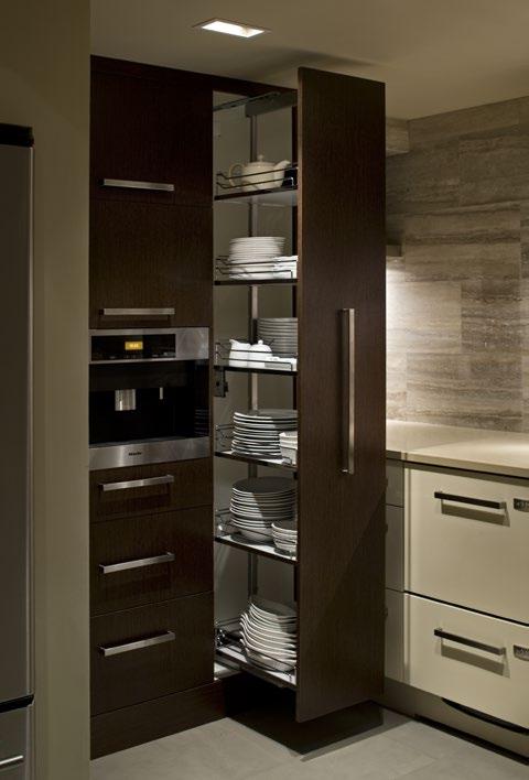 DESIGN This tall chocolate-brown corner unit houses dishes on pull-out shelving. Beside it, a Miele plumbed coffee machine was equipped with a cup-warming drawer.