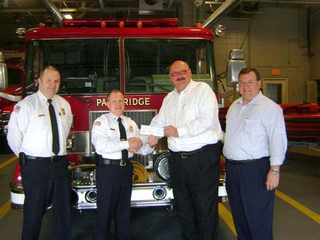 Highlight of the Month Fire Administration Deputy Chief Sorensen (left) and Fire Chief Zywanski (2 nd from left) receive a grant check from