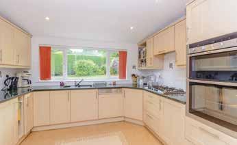 There is a generous kitchen with granite work surfaces (with built-in Neff appliances including a double oven, LPG gas hob, dishwasher, microwave) and breakfast room with adjoining utility which in