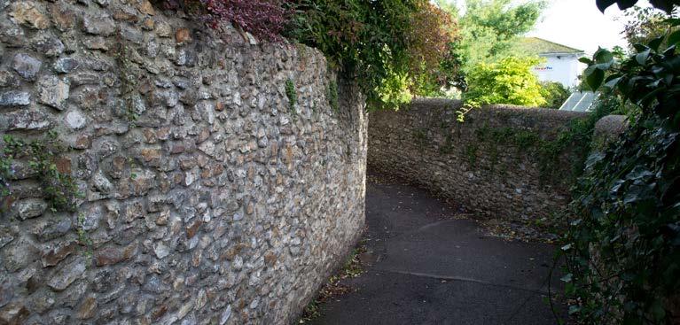 stone boundary walls with brick piers, and