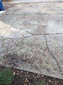 Driveway spacers missing, uneven surface.