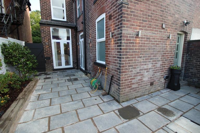 To the side and rear of the property there is paved patio areas, boundary wall, feature