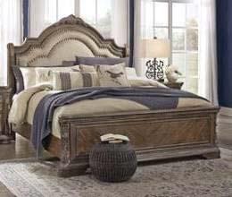 B803 Charmond (Signature Design) Classic traditional styling in a sophisticated dark brown oak finish with a white glazed accent Shapely panel bed has inset tufted headboard cushion in a beige color