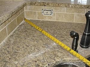 spacing that is required for wall counter spaces does not apply to island countertops. In other words, if the island counter was 48 in. x 48 in.