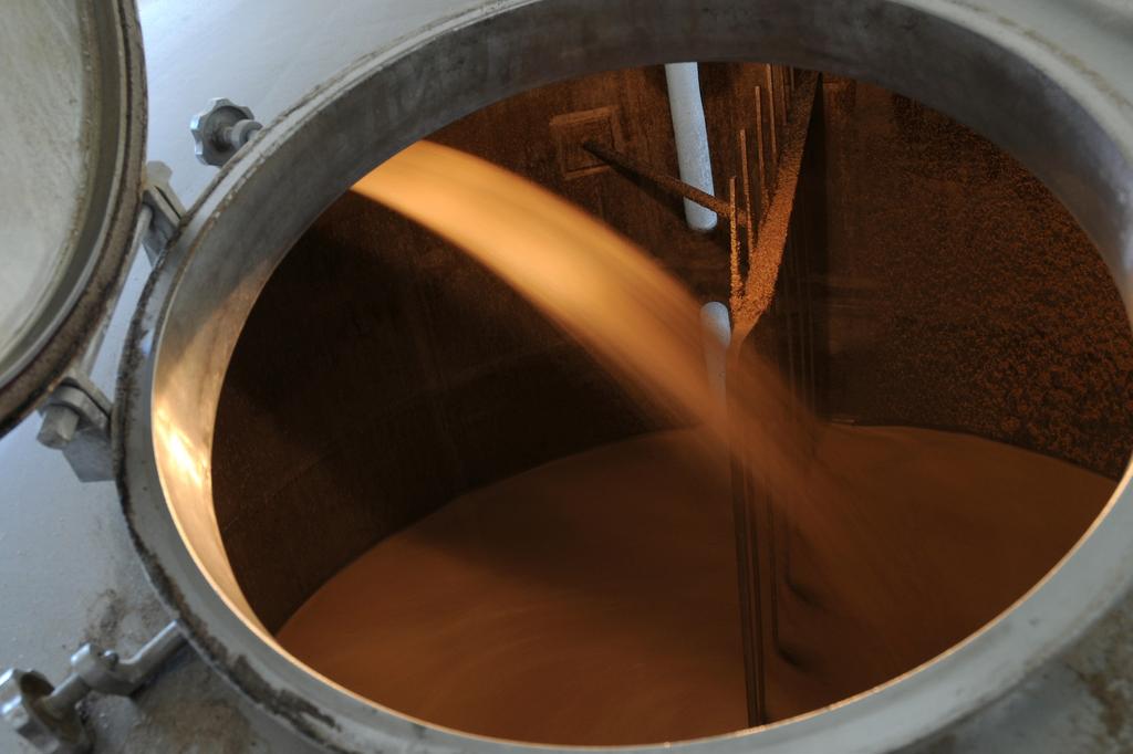 A mash tun with thick slurry, solid-laden malted barley and hops. The mash is wonderfully aromatic but difficult to transfer between vessels.