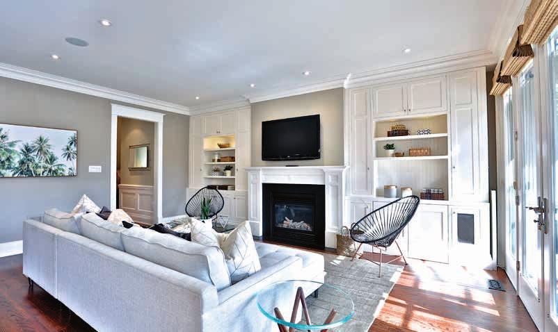 MAIN FLOOR Family Room High ceiling Abundance of natural light Gas fireplace flanked with custom built-in cabinetry