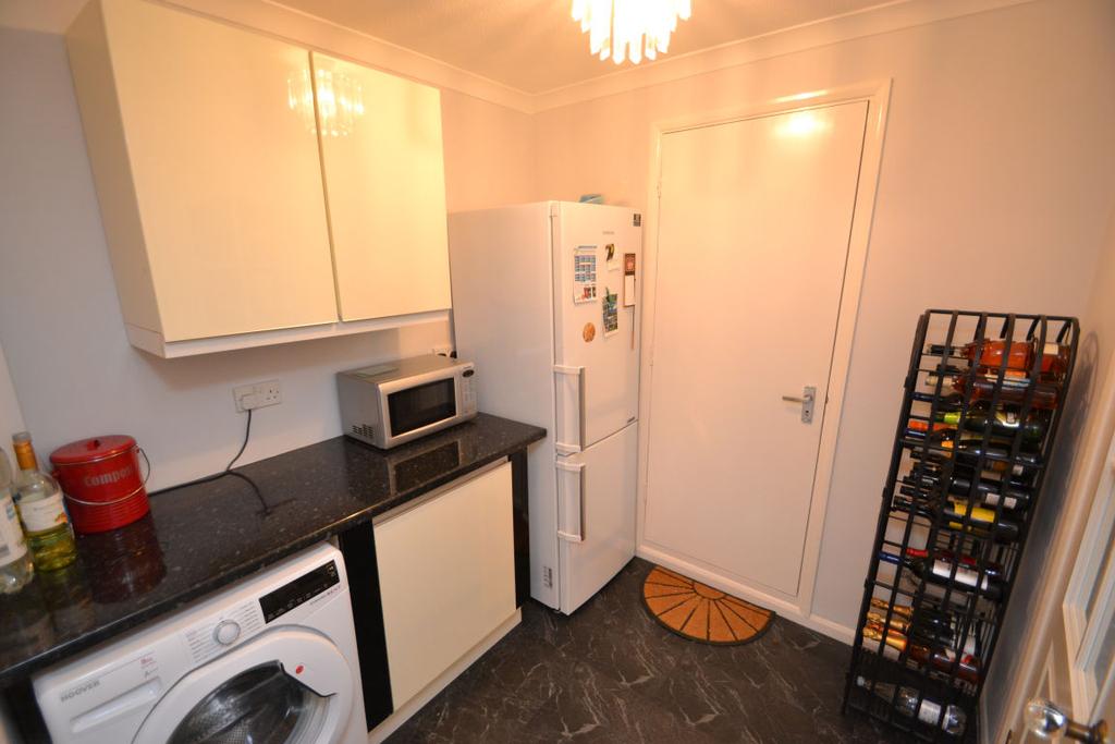 04m) Vinyl flooring, a range of eye and base level units with complementary work surface, inset sink and drainer. Built-in double oven, 4 ring gas hob with extraction over and integral dishwasher.