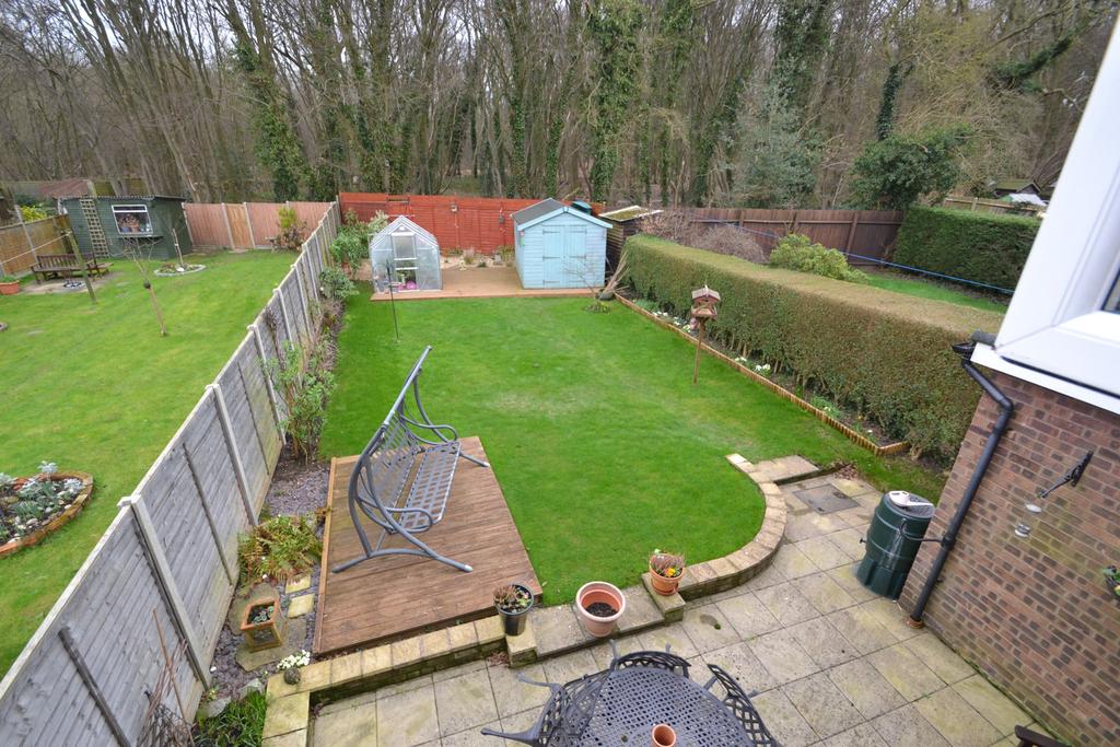 OUTSIDE: A beautifully presented and more than ample rear garden which is mainly laid to lawn with borders to either side and panel fencing.