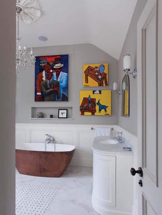 Mixing it up, the bathroom combines timeless design with on trend copper and quirky wall art.