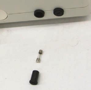 Using a level surface, place the Control Unit on its base, with easy access to the black round fuse cap located on the side of the unit (closest to the connectors).