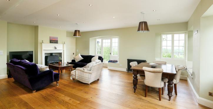 A doorway from the drawing room leads through to the huge kitchen/family room which features elegant natural oak flooring and a large wood burning stove built into the open chimney breast.