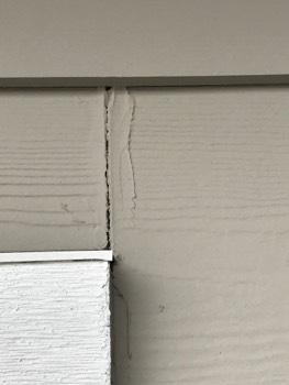 Voids in the caulking at some of the siding butt