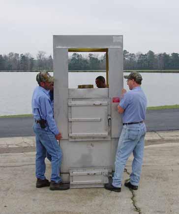 The door is easily removed by lifting up on the handle and taking it out. With the back door removed, using a 5/16 wrench, remove the 8 metal screws that are located below the back door.