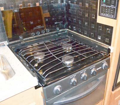 RANGE AND OVEN WITH GLASS RANGE COVER NOTE: See the appliance manufacturer s user guide provided in your InfoCase for complete operating instructions and safety precautions.