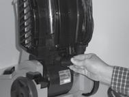 From the back of the vacuum, slide the base of the handle firmly into the grooves at the top of the vacuum body.