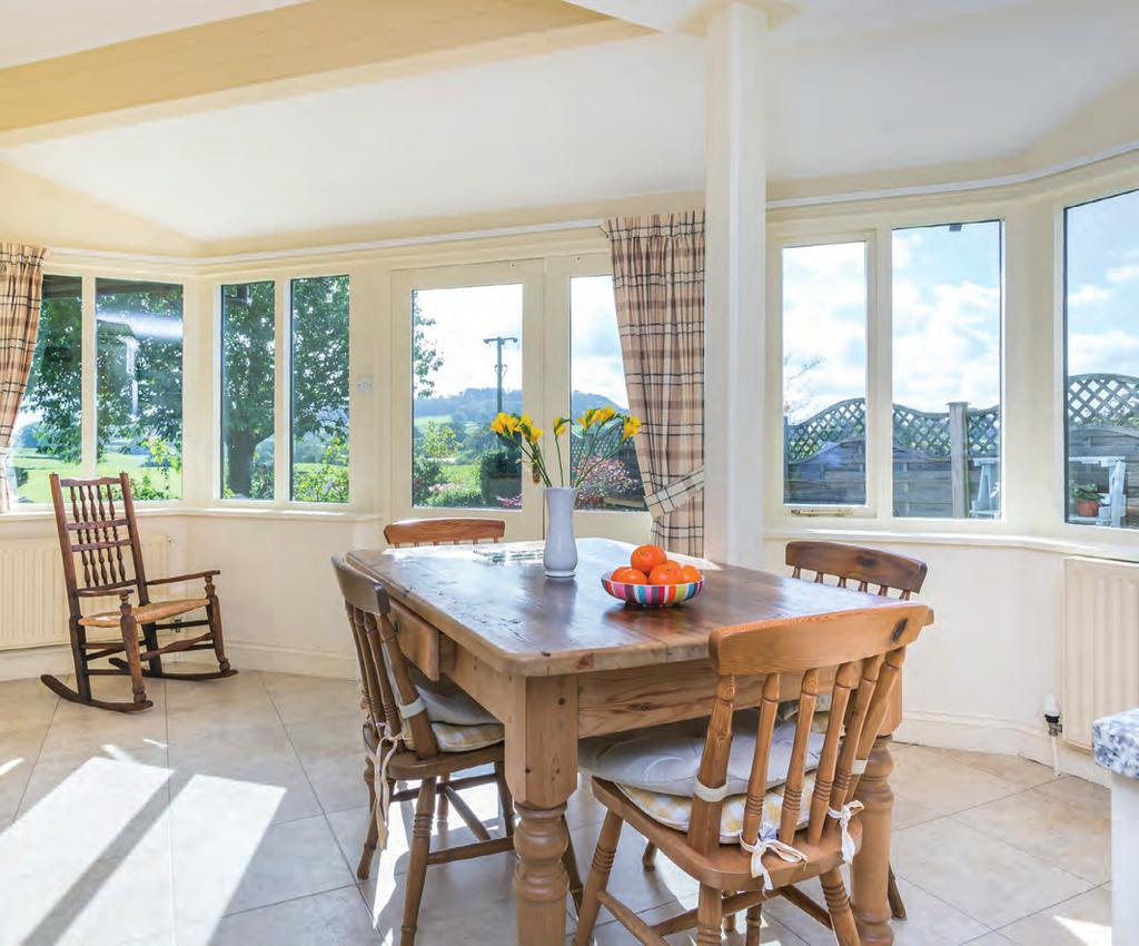 Four steps lead down to the lower ground floor where there is a dining room offering views to Farleton Knott and a beautiful sitting room that is filled with natural light and features a Clear View