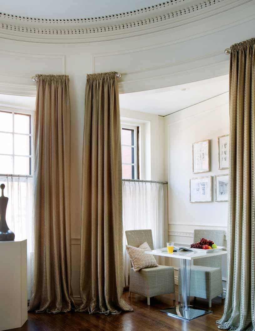 In the family room, cafe curtains provide privacy while long drapes add drama.