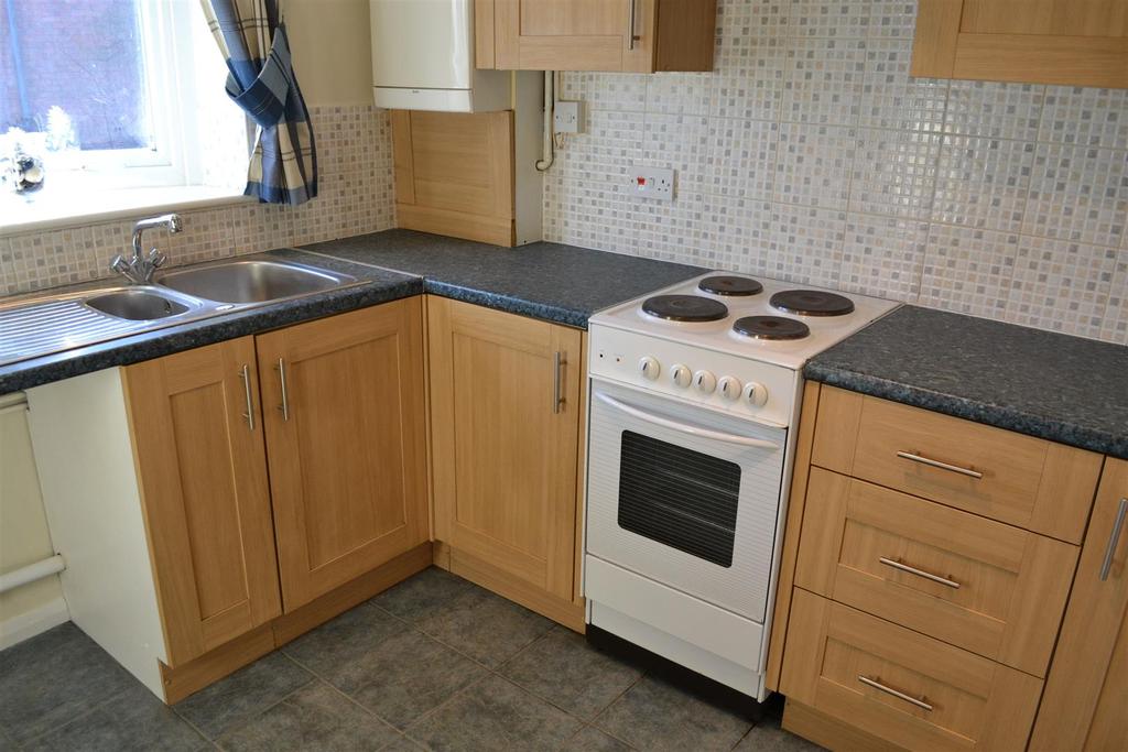 (continued) Kitchen 8'9 x 8'5 (2.67m x 2.57m) The kitchen is fitted with a range of wood grain fronted wall and base units with contrasting work surfaces over. Inset 1.
