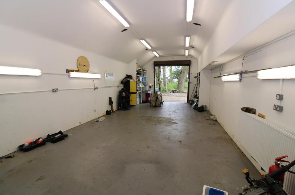 The workshop has separate vehicular access to the side with electrically operated roller door.