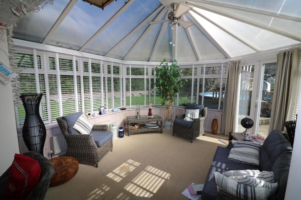 Conservatory measuring 13 3 x 13 (4.05 x 3.96m) being hexagonal shaped, comprising of double glazed panels with blinds.