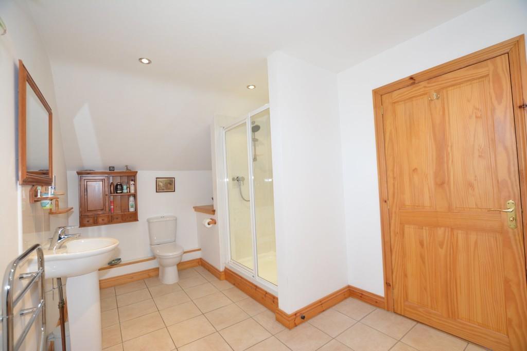 46m) white suite comprising corner bath with jacuzzi and shower over, pedestal hand basin, low flush WC and electric towel rail, tiled floor, window to the