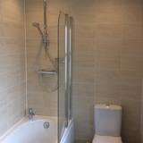 Bathroom Walls & Decor Full height pale brown rectangular ceramic wall tiles with white edging sealant, white grouting and white painted